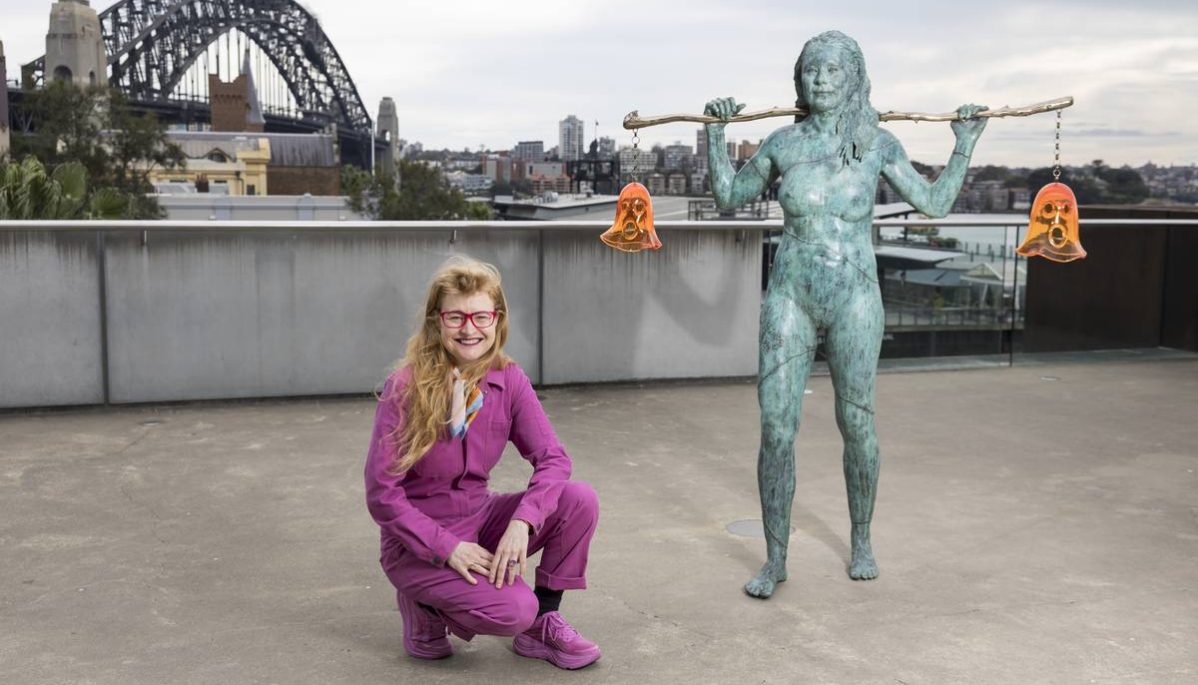 Nell crouching by her Scultpure Installaion 'Holding Both' on the Loti Smorgon Terrace at the Museum of Contemporary Art in Sydney. In the background is the Sydney Harbour Bridge.