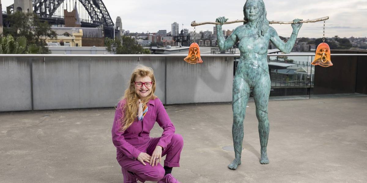 Nell crouching by her Scultpure Installaion 'Holding Both' on the Loti Smorgon Terrace at the Museum of Contemporary Art in Sydney. In the background is the Sydney Harbour Bridge.
