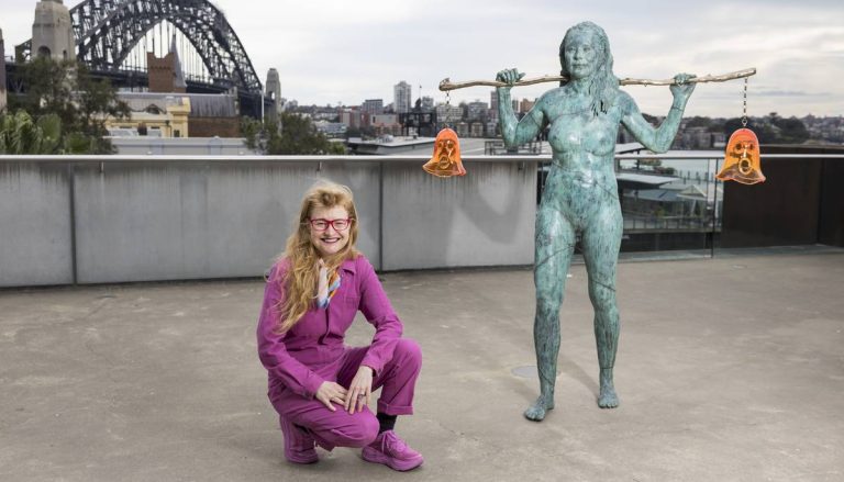Nell crouching by her Scultpure Installaion 'Holding Both' on the Loti Smorgon Terrace at the Museum of Contemporary Art in Sydney. In the background is the Sydney Harbour Bridge.