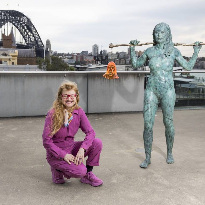 Nell crouching by her Scultpure Installaion 'Holding Both' on the Loti Smorgon Terrace at the Museum of Contemporary Art in Sydney. In the background is the Sydney Harbour Bridge.